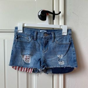 Girls Old Navy Jean shorts with an American flag print in the pockets.